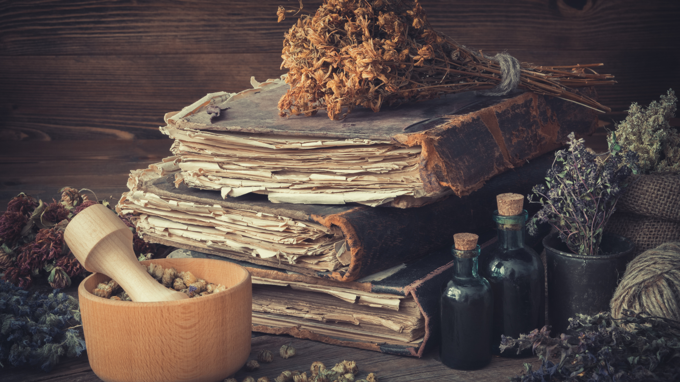 Little Witch Stories - a stack of old books behind a mortar and pestle and beside some old glass bottles.